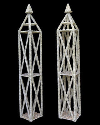 AN ARCHITECTURAL PAIR OF ITALIAN 1970'S WOODEN LARGE OBELISKS ENCRUSTED WITH SEASHELLS.Each towering scaffold-like open obelisk; with four inclined corner supports and one central shaft joining three graduated quadrangular platforms (one suspended