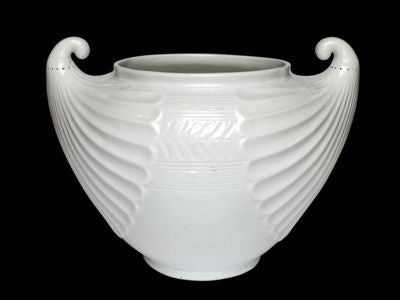 A SPIRITED ITALIAN ART DECO WHITE GLAZED POTTERY LARGE DOUBLE-SCROLL HANDLED VASE. The wide level-lipped circular neck over a bulbous body on a formed round base; the body impressed with horizontal groves centering a central panel of chevrons and