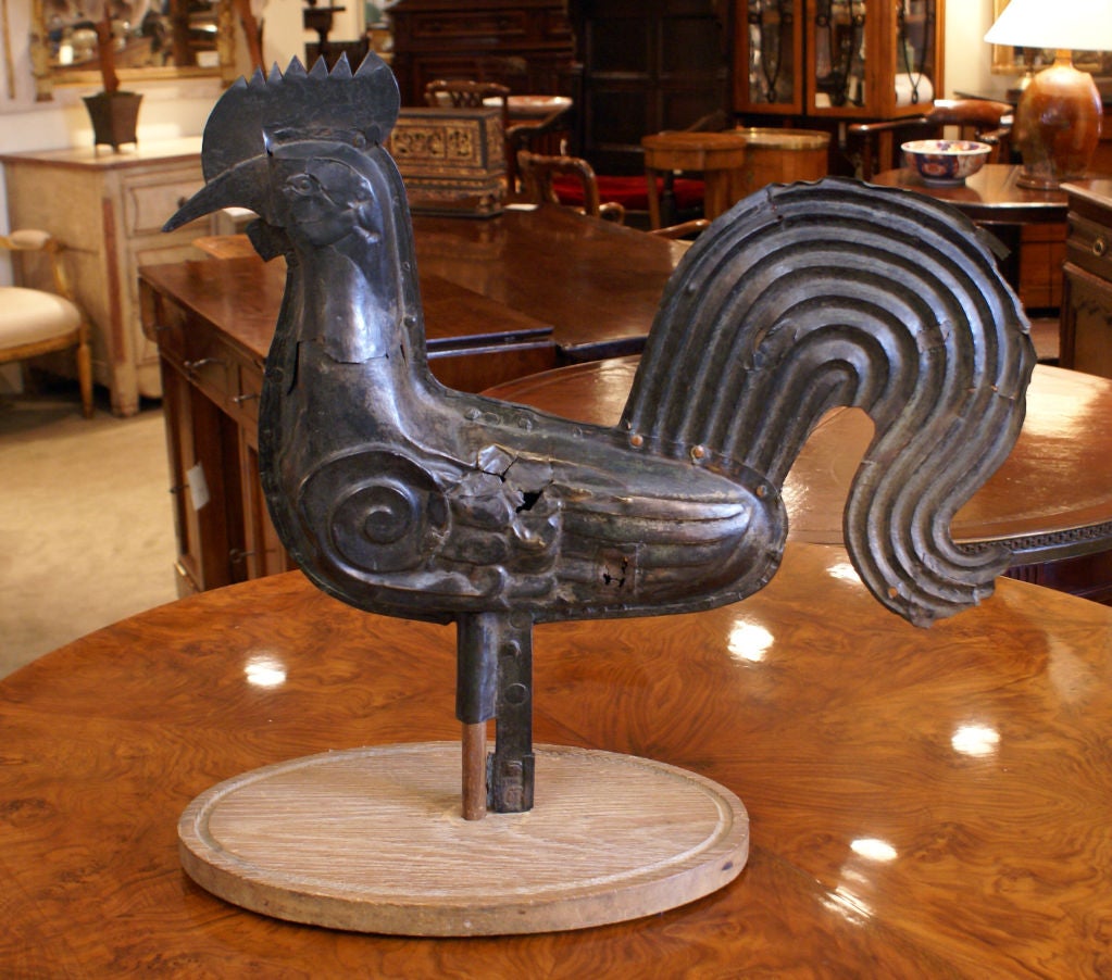 A very nice and large late 18th or early 19th century French rooster weathervane on a later wooden base. This piece has lots of character and patination. It has been used for target practice a few times.