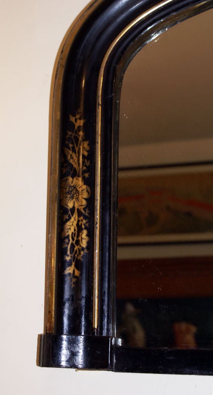 Victorian black lacquer and silver gilt over mantel mirror with some gilt painted decoration over the black ground.  ...