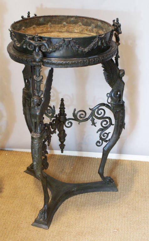 A pair of 19th century patinated bronze stands, Athienienne, based on a Roman original found at Pompeii. A matching tripod was used at the baptism of Napoleon's son, the king of Rome. This type of Stand was copied during the 18th-19th centuries.
