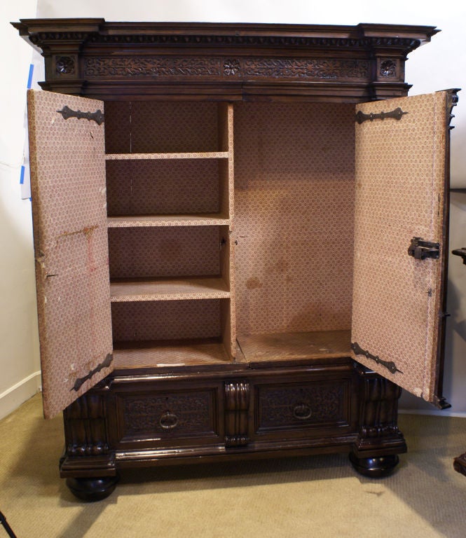 A very handsome architectural Baroque Cabinet. Two cabinet doors are flanked by Outset Corinthian fluted columns. The paneled doors with carved scrolling decoration. The cornice features egg and dart molding, carved decoration and rosettes. Some