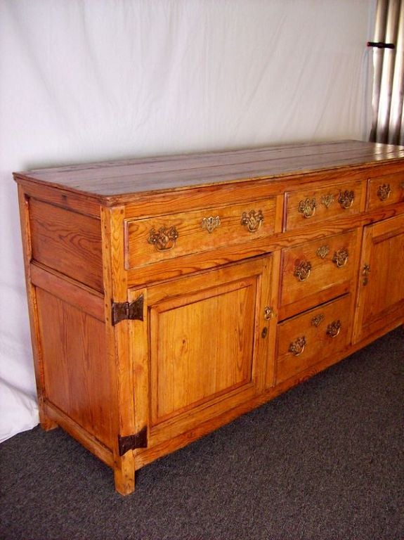 An exceptional 18th century Yorkshire base. All of the handles, escutcheons, and hinges are original. The pine is a beautiful, honey color with a rich patina. Terrific storage with five drawers and two cabinets. At 74