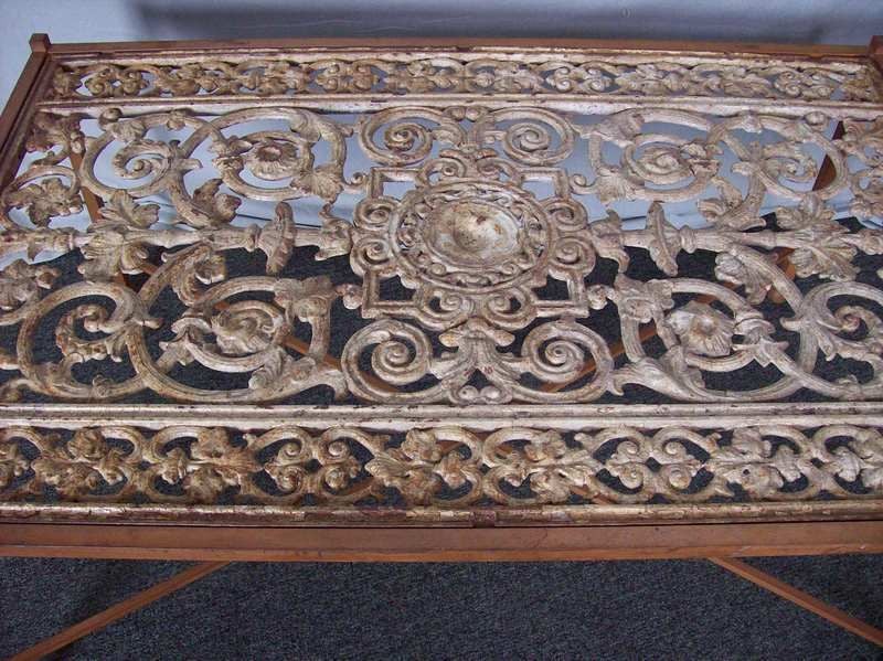 An antique window grille from France set into a custom base. This grille has old paint, and the base is a beautiful bronze color. One could put a glass top of any size, to rest on the four corners. A glass top is not included.