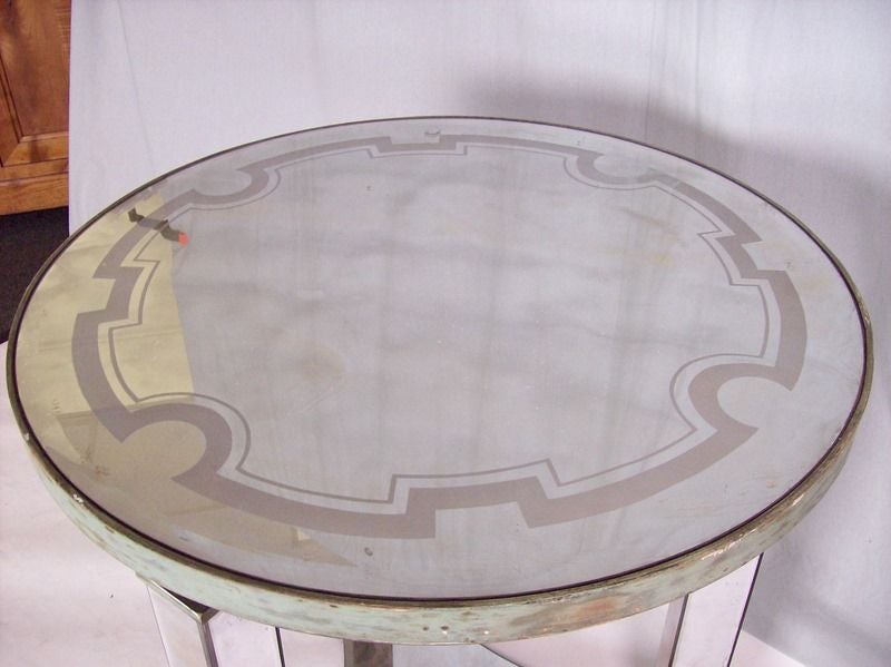 Fabulous mirrored Deco round table from France. The glass has wonderful age and patina. Top is beveled and has a decorative pattern on the glass (see first thumbnail). Enough presence for a center table, but could also be used as a lamp or end