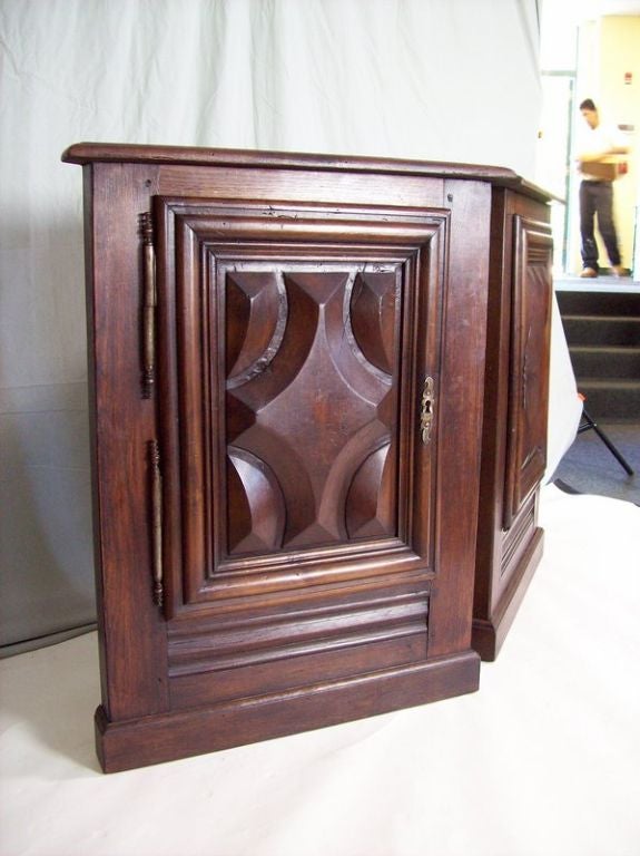 A pair of antique corner cabinets from Bearn in southwest France. Note the beautifully carved panels on the doors. Original escutcheons, hinges and keys. The dark chestnut has great warmth and patina. One shelf inside for storage. Price is for the