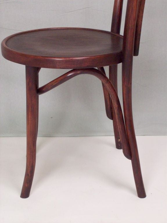 Six Classic bentwood Thonet-style side chairs from Czechoslovakia. Classic bentwood details around the legs with sturdy and comfortable round seats. Restored deep rich color. The price is for six.