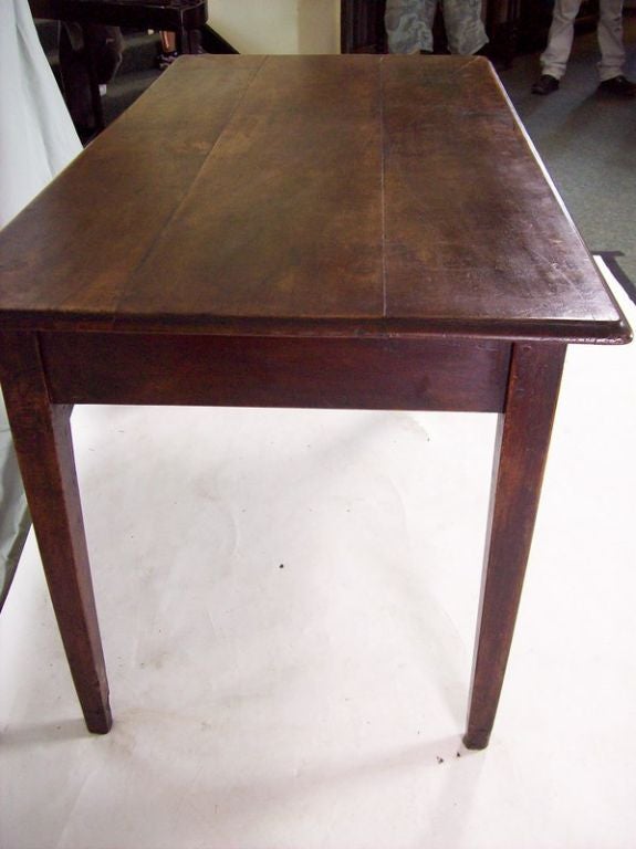 An antique two drawer writing table from France. The walnut has a beautiful color and a rich patina. Very pretty ogee edge. A good 24 1/2