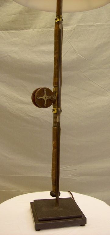 An early fishing rod and reel from England, newly constructed into a tall table lamp.  All of the working elements of the rod have been preserved, including the fishing line on the reel.  Height measurement number 1 is for the lamp itself, and