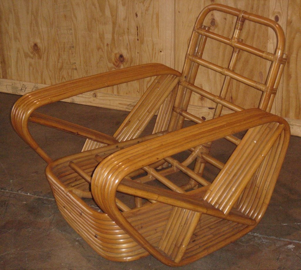 This armchair is part of a collection of pieces brought to the U.S. from Japan and owned by the same family since the 1950's. Each piece is of authentic Japanese design with multiple curved bands and evidences hand-made workmanship of the highest