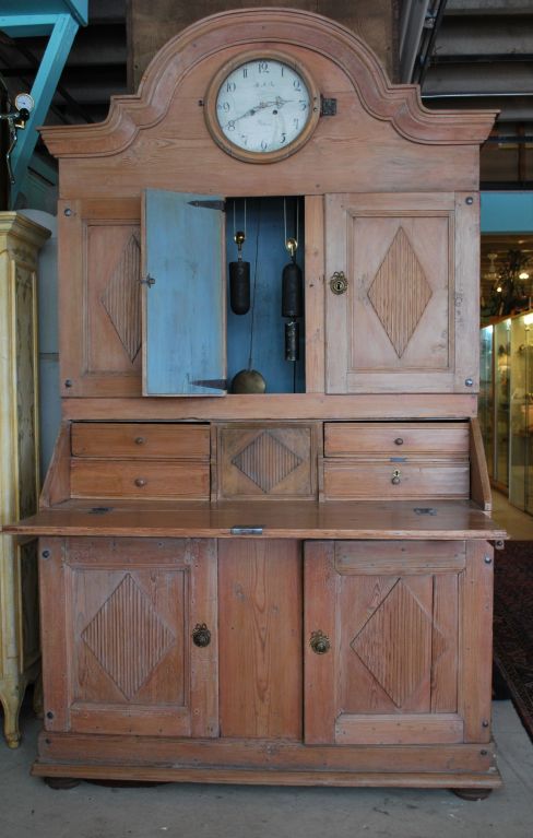 All original; very impressive pine secretary/ desk with its original clock and movement that strikes on the hour. The clock face is marked 