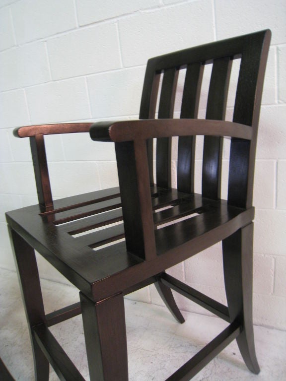 Oversize Michael Taylor bar stools. Dark mahogany.