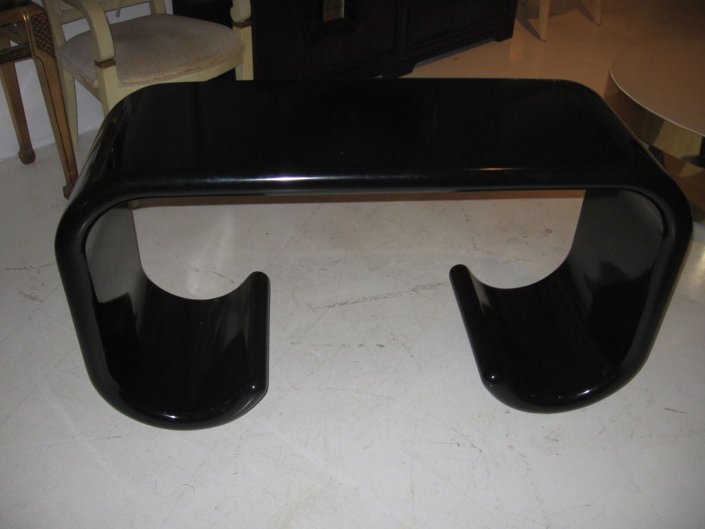 Pair of black lacquered wood consoles / sofa tables, in waterfall design.<br />
CAN BE PURCHASED INDIVIDUALLY.<br />
.