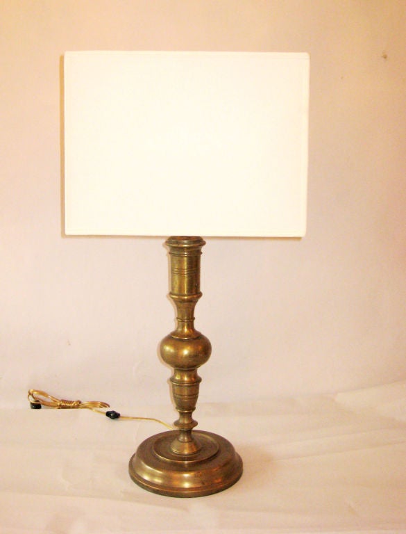 Elegant and Timeless Pair of French Mid-Century Modern Neoclassical Solid Brass / Bronze table lamps circa 1930 in the style of Jean Michel Frank. The lamps are special in their classic form, significant materials, refined workmanship and imposing
