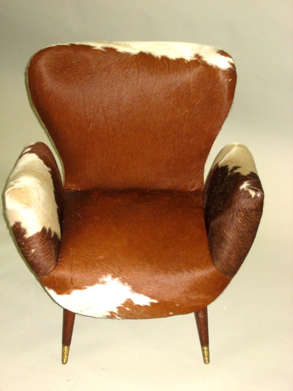 Pair of Armchairs Covered in Cowhide in the Style of Carlo Mollino. Note the Organic Forms of the Backrest and the Arms which are Separated from the rest of the Frame Providing Practical Comfort and a Sense of Fantasy.