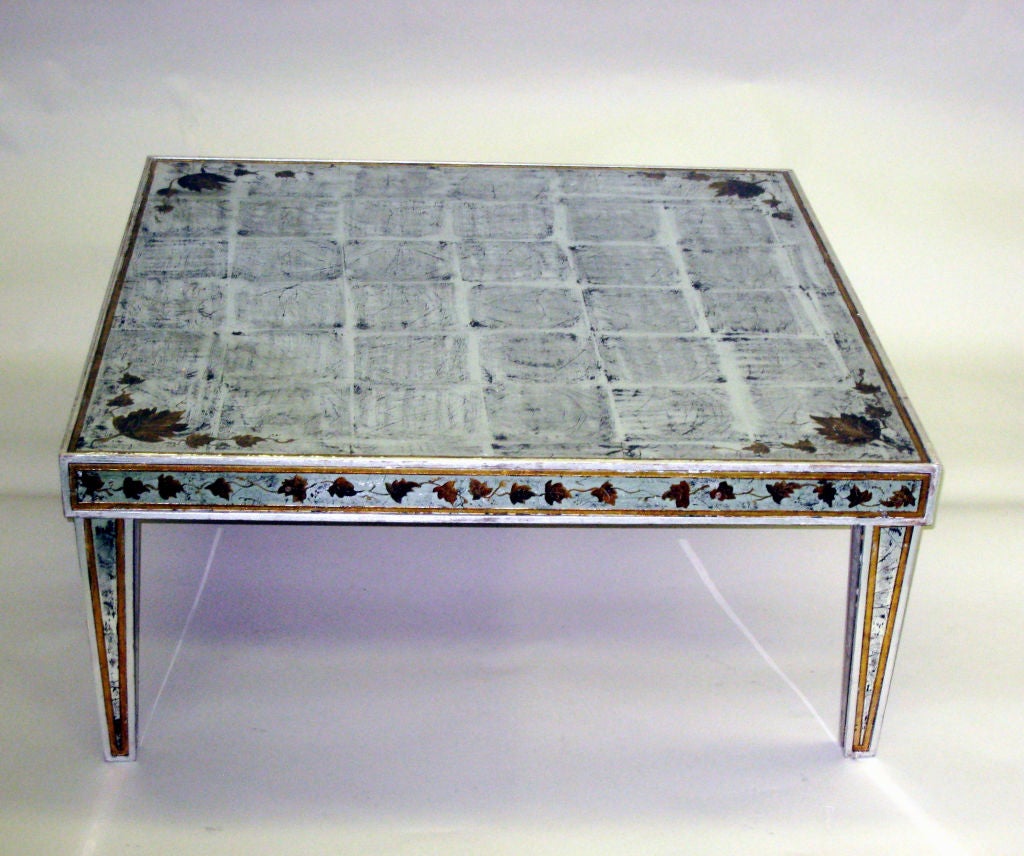 Important French midcentury reverse painted glass coffee table with silver leaf top and legs decorated in a leaf pattern and in an elegant square form.

Maison Jansen made a piece with similar styling for the Duke and Duchess Windsor's Estate in