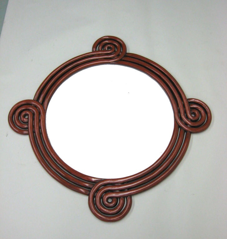 An original French Mid-Century Modern hand carved hard wood wall mirror in a 'Perpetually Curving' form and lacquered red-orange. 

A stunning piece of design, Craft and hand work.