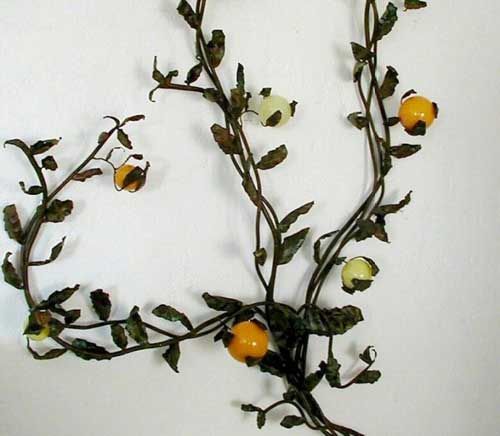 Extraordinary wall-mounted sculpture featuring a hand-wrought iron structure of a citrus tree with Murano glass oranges and lemons inset into the tree.

The piece was commissioned to and executed by Barovier e Toso by a Holllywood client in 1950.