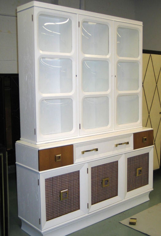 A stunning blend of modernism and classicism informs this double level secretary / sideboard / etagere / vitrine with fold-out writing table /desk top. There is an elegant contrast between white lacquer, hand caned doors and blown Bombayed glass