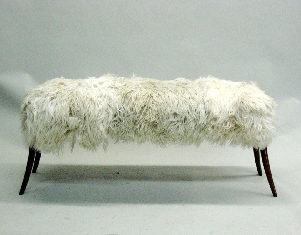 A chic Italian Mid-Century Modern style, hand carved bench or stool with delicately tapering and angled legs with the seat covered in long haired goatskin.

Available for order in custom sizes.