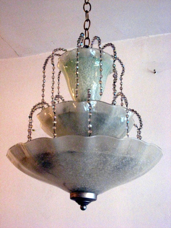 An elegant handblown venetian glass chandelier/pendant attributed to Barovier e Toso with crystal beads dropping from succeeding levels of glass pools creating a waterfall effect. This singular piece balances modern neoclassical design with sublime