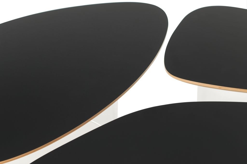 A set of tables of black laminate, beech plywood and base of PMMA (polymethyl methacrylate) designed by Janette Laverrière (b. 1909). Signed and Numbered. From the limited edition of 25.