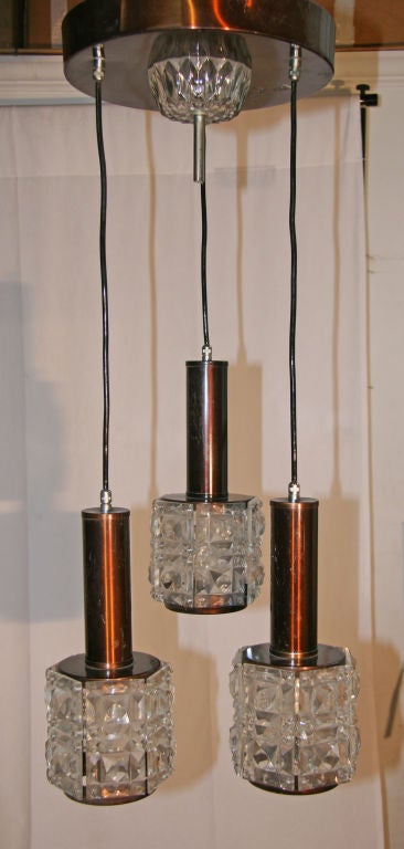 Cut glass cubes suspended with copper plate. Nice for the entry, dining, bath, kitchen, bedroom....