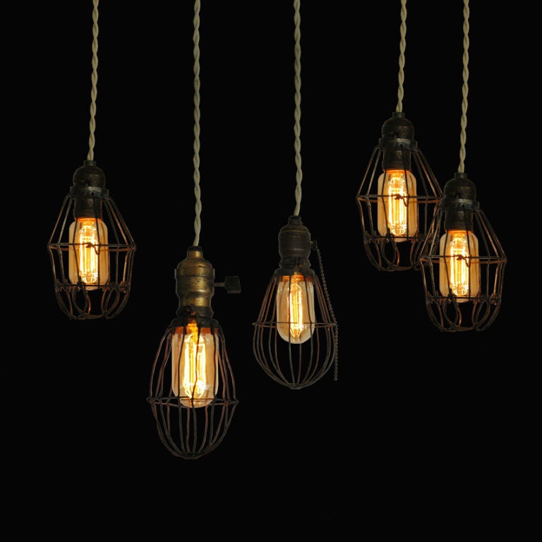 Three metal cage lights from 1915-1920s.  Shown with Edison bulbs.  Lights measure 7-9