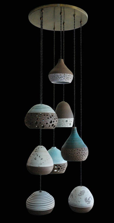 Wheel thrown stoneware with porcelain slips and high fired glazes.  All have intricate cutout deigns.  Priced individually