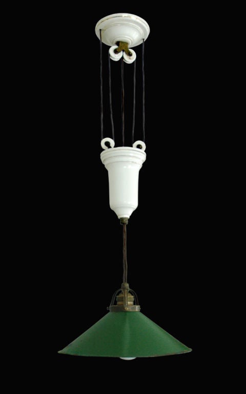French pulley light with porcelain features and green enameled shade.  Shade is white on the interior.  Fixture is in original condition with new wiring.  Fully extended the length is 46