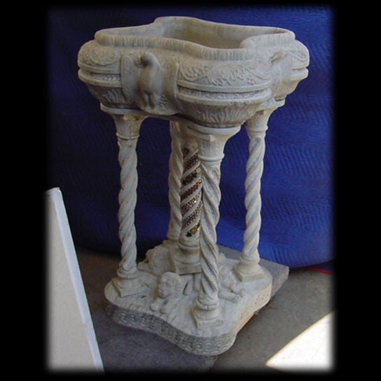 Very fine 19th century Italian white marble bird bath with grapes and vines around the perimeter and winged doves on each side. The bath is supported by five spiral columns. The center column has a beautiful mosaic inlay. The base features four
