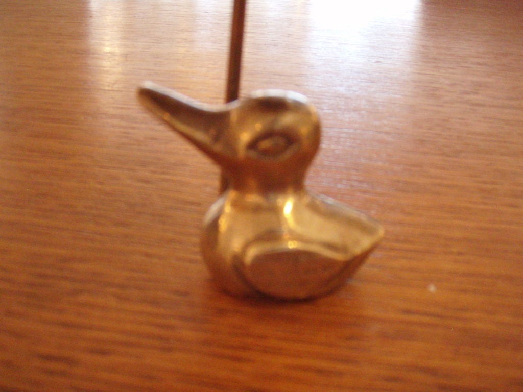 Solid brass duck figurine with umbrella.
