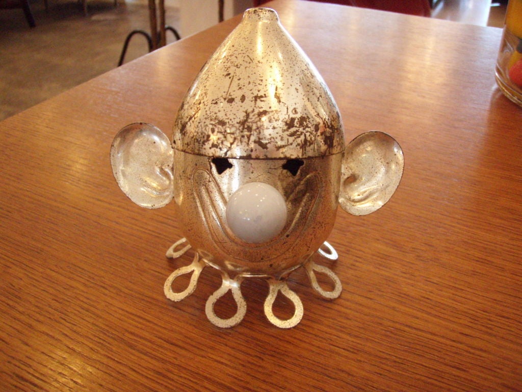 Chrome plated bank with floppy ears and a pale blue glass marble nose.<br />
<br />
During The Middle Ages, in about the fifteenth century, metal was expensive and seldom used for household wares. Instead, dishes and pots were made of an