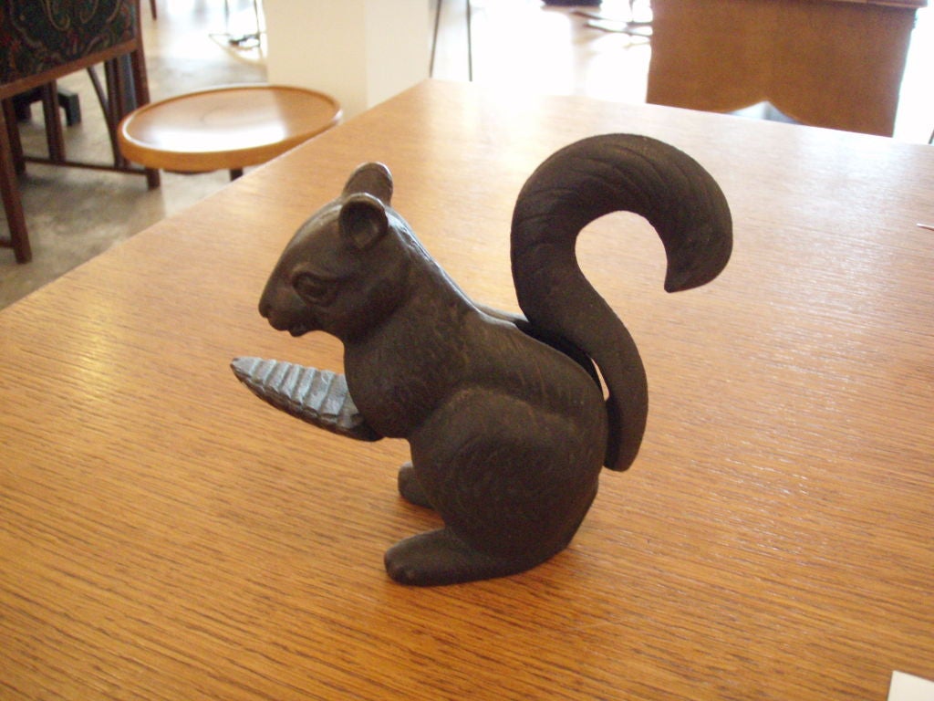 Press the tail down and the squirrel's hands press up to his mouth to crush the nut.  Great detail to this piece.