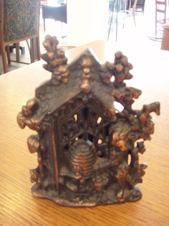 Depicts a bear stealing the honey skep.  Single screw closure on back.<br />
<br />
During The Middle Ages, in about the fifteenth century, metal was expensive and seldom used for household wares. Instead, dishes and pots were made of an