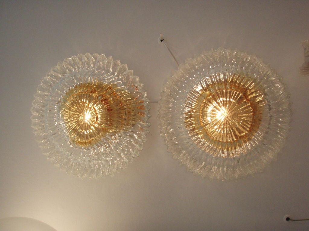 Textured orange and clear glass with chrome hardware.  One light bulb in each sconce.