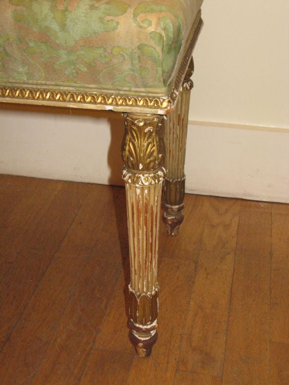 Louis XVI Style ‘Banquette’ with rectangular padded seat.    Carved gilt-gesso frame (c.1880) is moulded and fluted with acanthus leaves topping tapered legs.  <br />
**newly upholstered in Fortuny fabric<br />
<br />
Frame:  French C. 1880