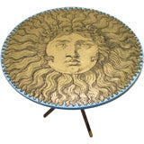 A Piero Fornasetti Gueridon Sunburst on a Gold Leaf ground.