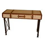 A fantastic rattan and leather desk on an iron base