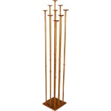 A gilt iron floor candle holder/coat rack