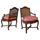 A Curvaceous Pair of French Regence Walnut Open Armchairs