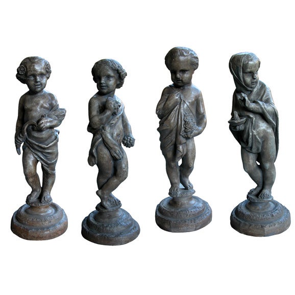 A Charming Set of Four French Molded Lead Garden Ornaments of Putti Depicting the Four Seasons