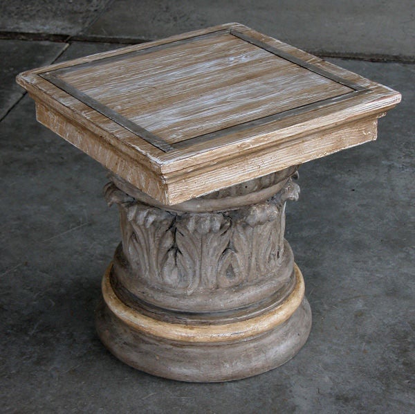 A handsome American neoclassical style gray painted and faux bois corinthian capital plinth or side table; the square faux grained top resting on a corinthian capital base with egg-and-dart molding above a ring of protruding acanthus leaves