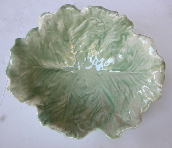 A large-scaled and finely-rendered American celadon-glazed ceramic lettuce-leaf bowl; stamped with Rookwood insignia; the large, deep bowl consisting of overlapping lettuce leaves with curled ends