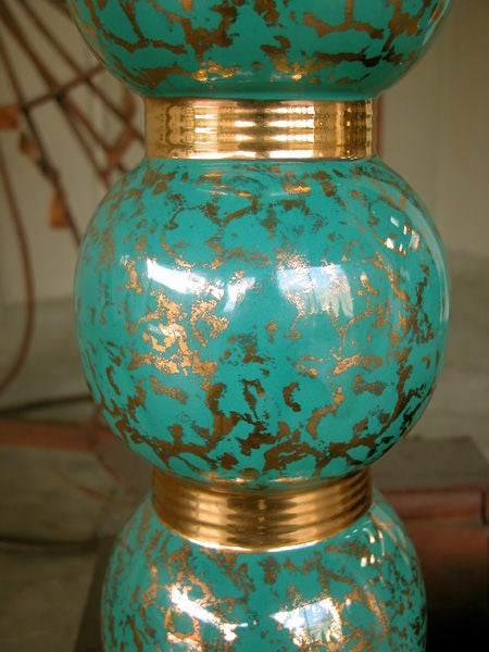 A stylish pair of Italian 1960's turquoise-glazed ceramic lamps of stacked spheres with gilt decoration; each lamp consisting of 3 stacked spheres with gilt highlights