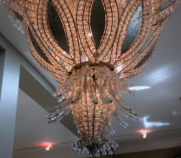 A magnificent French Ananas art deco chandelier; white gold leave with glass pearl beads, mounted on silvered iron frame; Provenance: Grand Hotel le Royal, Chalons sur Saone.