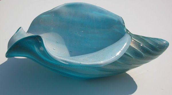 A large and stunning Italian mid-century pale blue cased glass conch shell bowl; of robust scale with deeply scalloped rim; the interior of white cased glass with controlled bubbles; the lobed underside of pale blue glass with gold aventurine