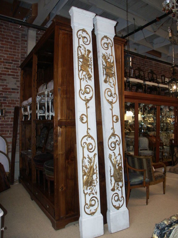 Great looking pair of tall white carved wood columns with musical themed carvings of violins and othe musical instruments