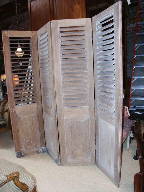 Great looking pair of pairs of shutters that have a limed looking finish.