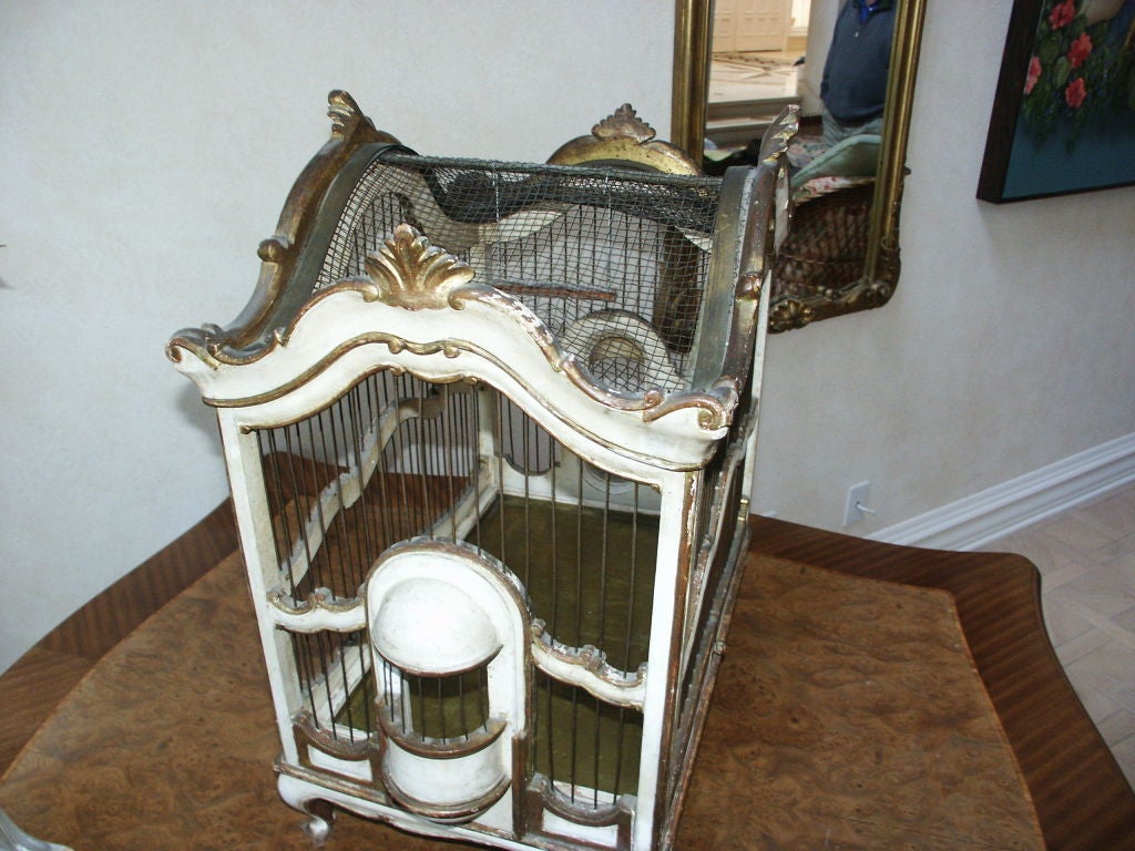 Antique Italian birdcage with carved wood body and gilt decoration and painted surfaces.